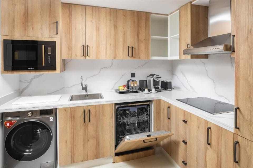Full-size fridge, microwave, cookware/dishes/utensils, dining table