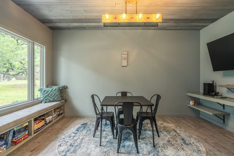 Cozy game room with a scenic window seat and a perfect setup for board game nights.