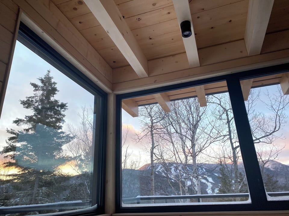 Master bedroom on the ground floor with corner view of Mount Edward.