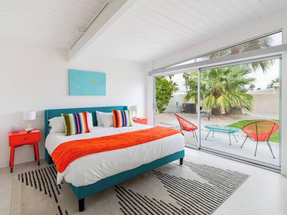 Master Bedroom w/ electric blinds and tinted upper window, smart TV that pulls out, built-in speaker system, and private master bathroom