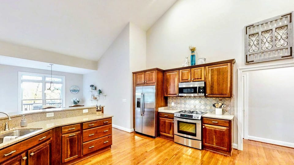Enjoy cooking with ease in this fully equipped kitchen featuring stainless steel appliances, a spacious layout, and elegant cabinetry that blends functionality with warmth.