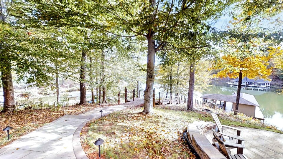 Stroll down this scenic, tree-lined pathway leading to the dock, where you can enjoy tranquil lake views and ultimate relaxation.