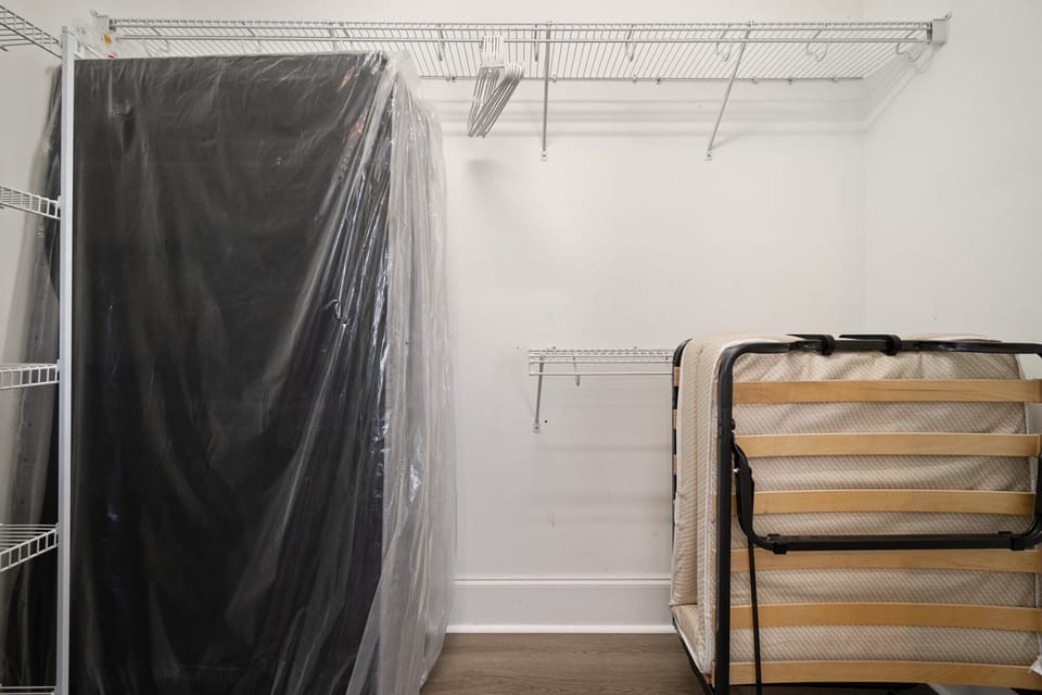 Your spacious walk-in closet offers ample storage with wire shelving and room for your folding bed when not in use.