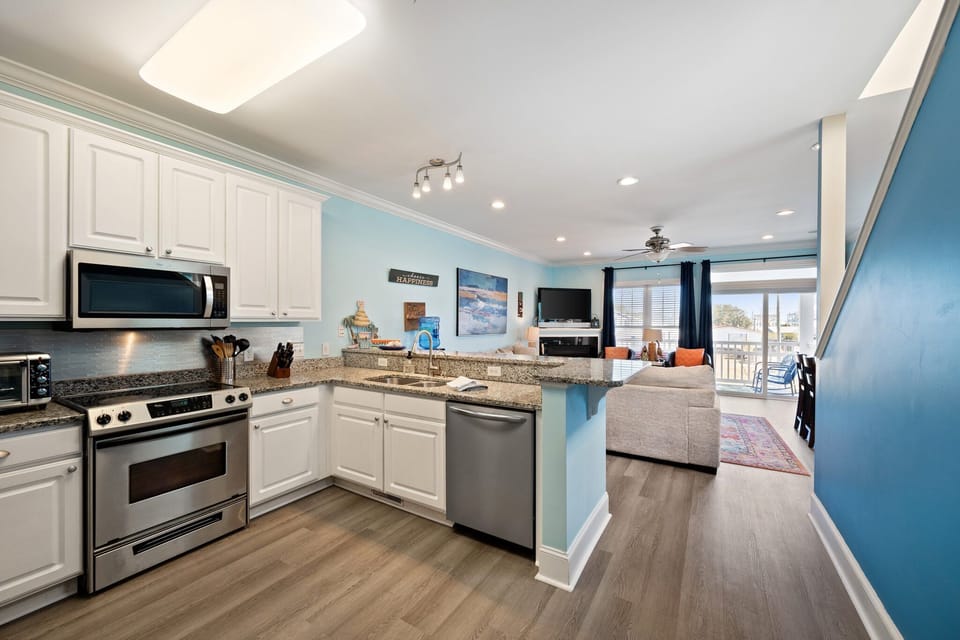 Your open kitchen flows seamlessly into the bright living space, perfect for preparing meals while staying connected with your group.