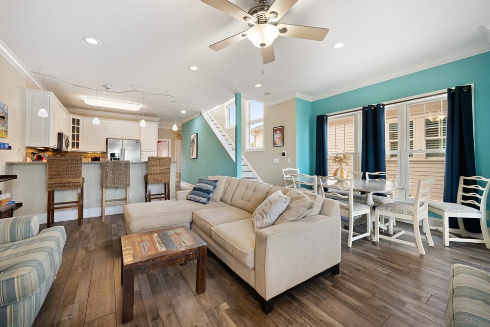 Step into your bright coastal retreat where the open-plan living flows seamlessly from kitchen to dining to relaxation space.