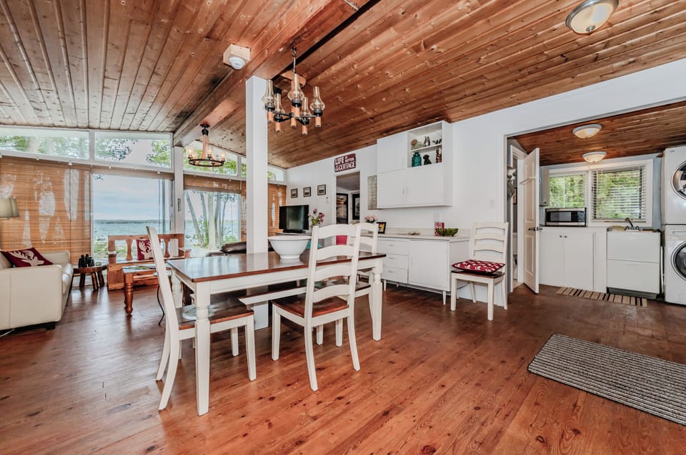Bright and spacious, this open-concept cottage layout features lake views, a full dining area, and cozy cottage vibes for memorable group getaways.