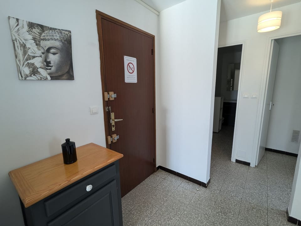 The hallway leads to the front door of the dwelling and is equipped with practical storage to optimize space