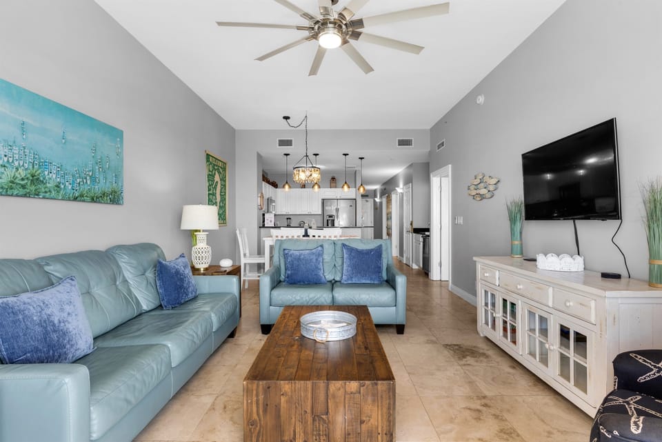 Living Room - Kick back in this bright living room with a comfy sofa and love seat, and a large comfy chair—ample seating for family and friends, with a queen sleeper sofa.