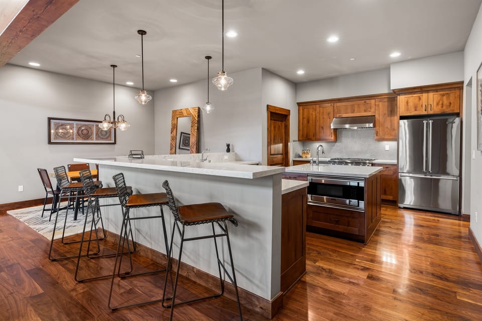 A chef's delight! The gourmet kitchen features sleek countertops, state-of-the-art appliances, and an island perfect for meal prep or casual dining.