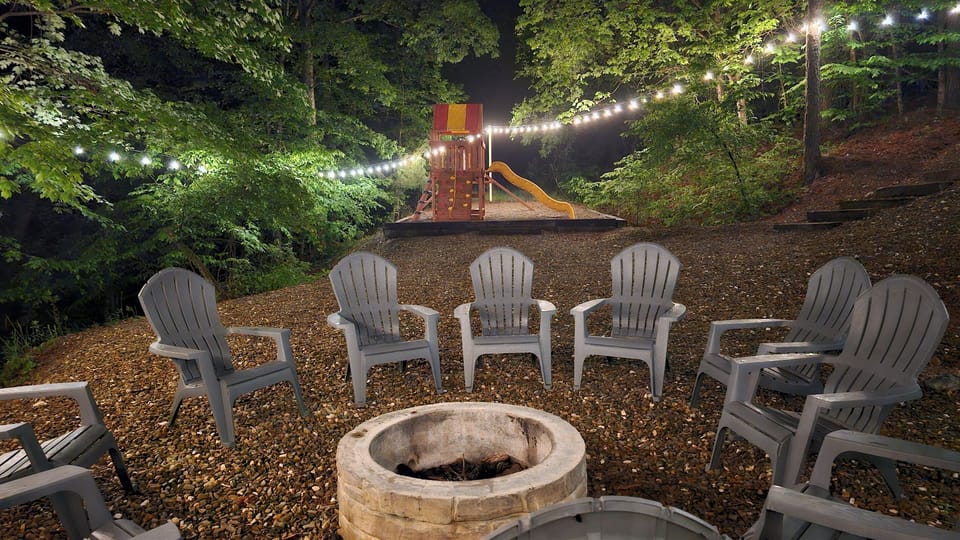 Firepit Area – Cozy firepit with string lights overlooking the woods—ideal for s’mores and evening gatherings.