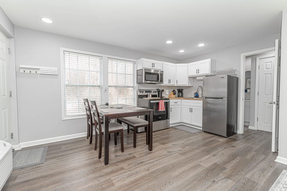 Cozy studio living with a kitchen and dining space for four. Perfect for shared meals and relaxation