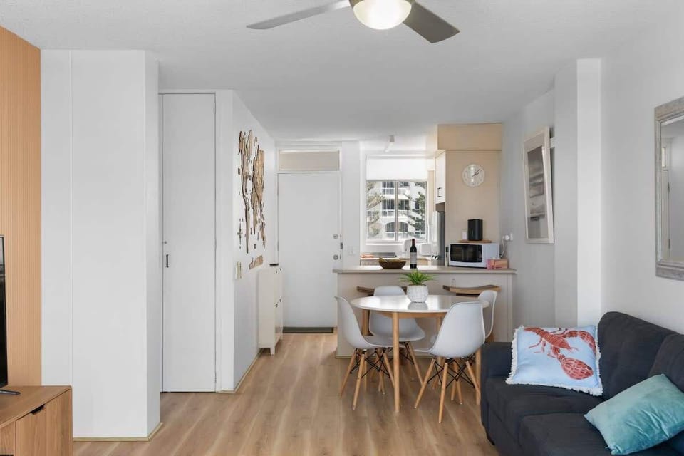 The dining table offers a cozy space for meals, featuring a clean, modern design.