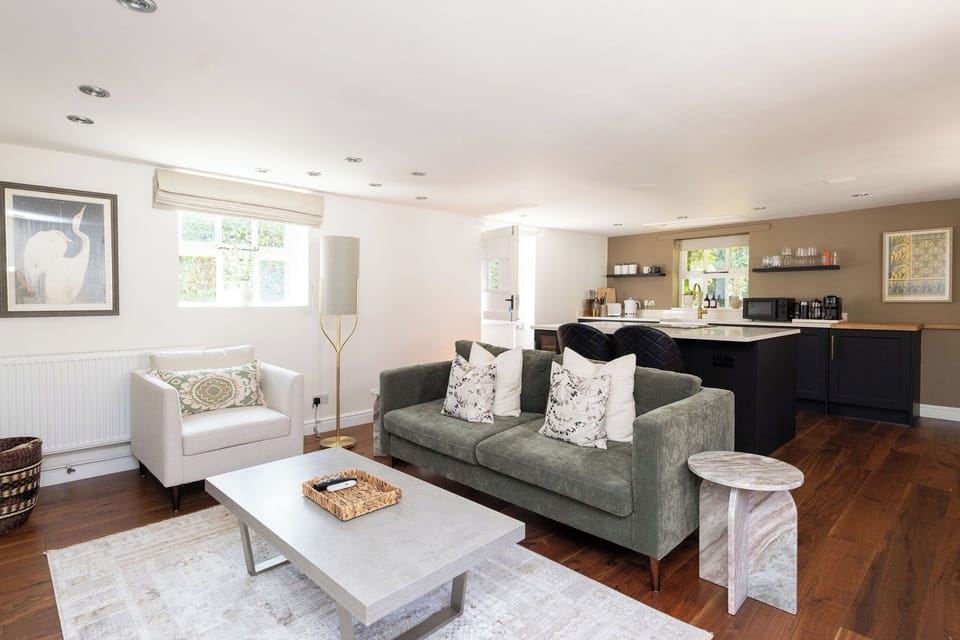 Open plan living area with kitchen behind 