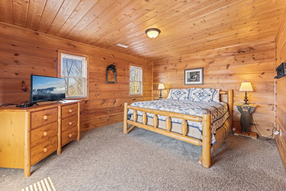 Bedroom 3 with king bed, deck access, TV, and private ensuite