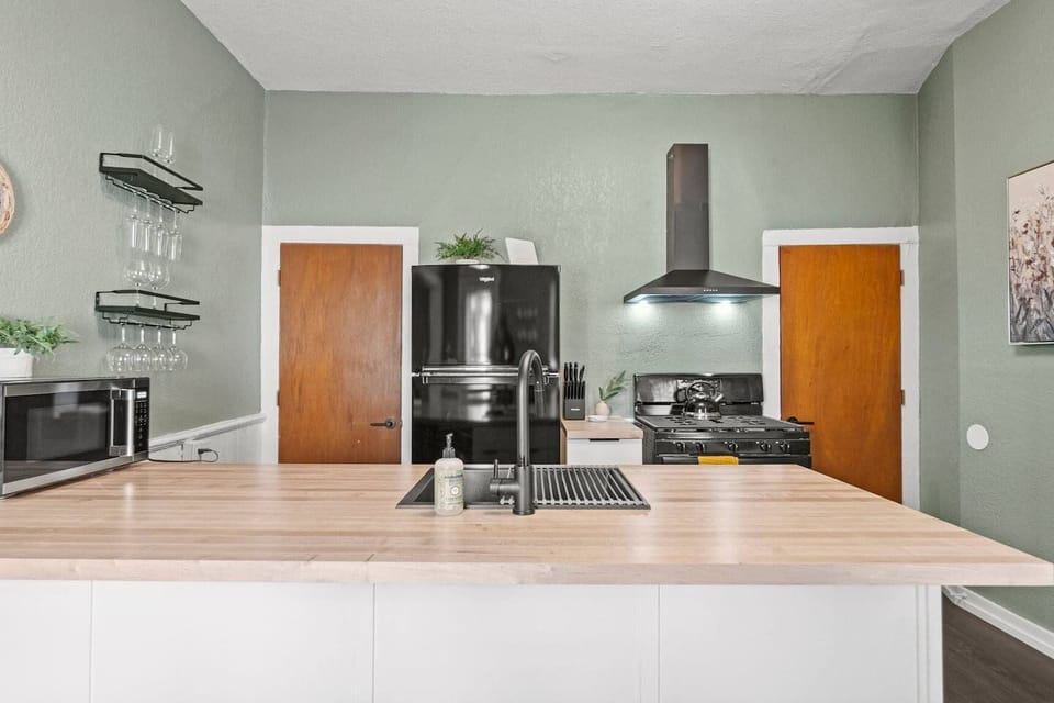 Cook up your favorite local ingredients on the premium gas range while chatting with guests seated at the butcher block island breakfast bar.
