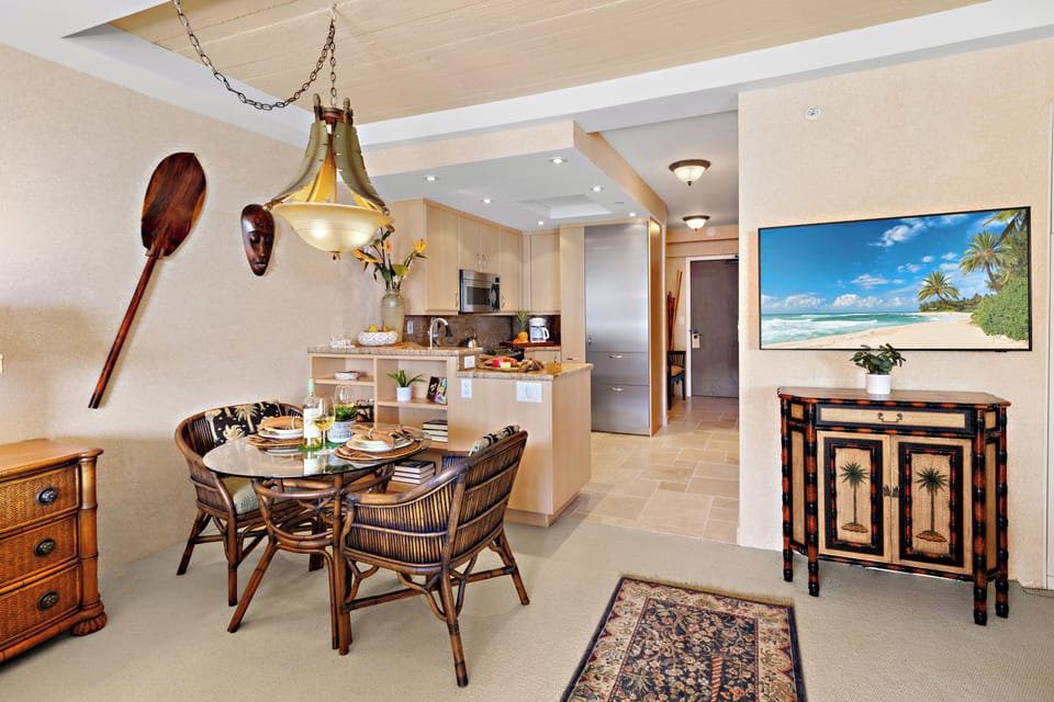An inviting dining space where island elegance meets breathtaking ocean views. Gather around the beautifully set table, surrounded by warm textures, coastal-inspired décor, and soft ambient lighting.
