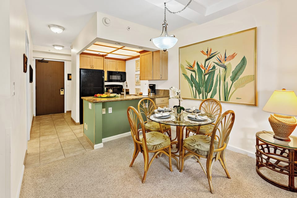 Bright and inviting open-concept kitchen featuring warm wood cabinetry, sleek granite countertops, and a spacious island that flows seamlessly into the living and dining areas. Perfect for entertaining or relaxing in comfort.