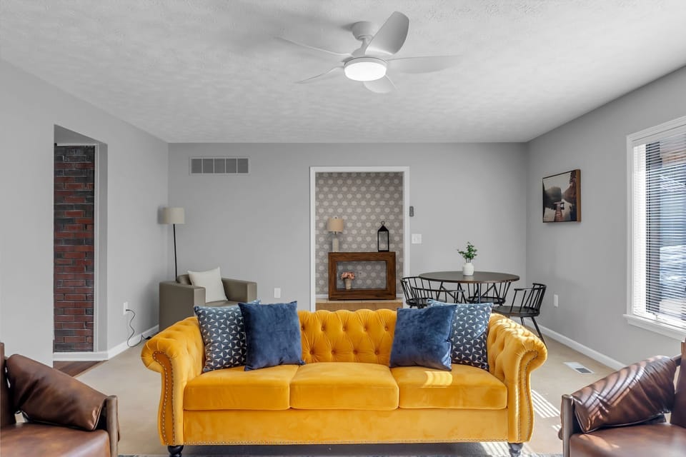 Thoughtfully designed living space with a bold yellow sofa for comfort and style.