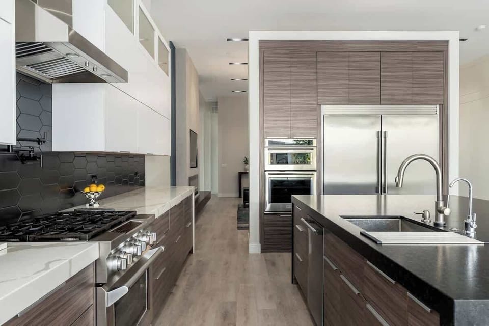 Picture yourself preparing meals in this sleek, fully equipped chef's kitchen, where modern appliances and elegant countertops make cooking a joy.