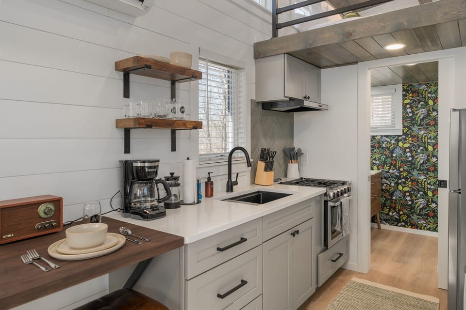 Kitchenette at Frost — compact and fully functional, coffee maker, sink, stovetop essentials