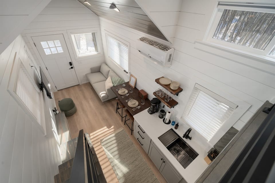 Main floor overview at Frost — living area below, lofted queen bed above, open and airy layout