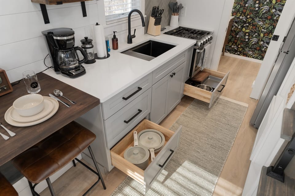 Kitchenette close-up at Frost — coffee bar, sink, counter space, and pantry basics stocked on arrival