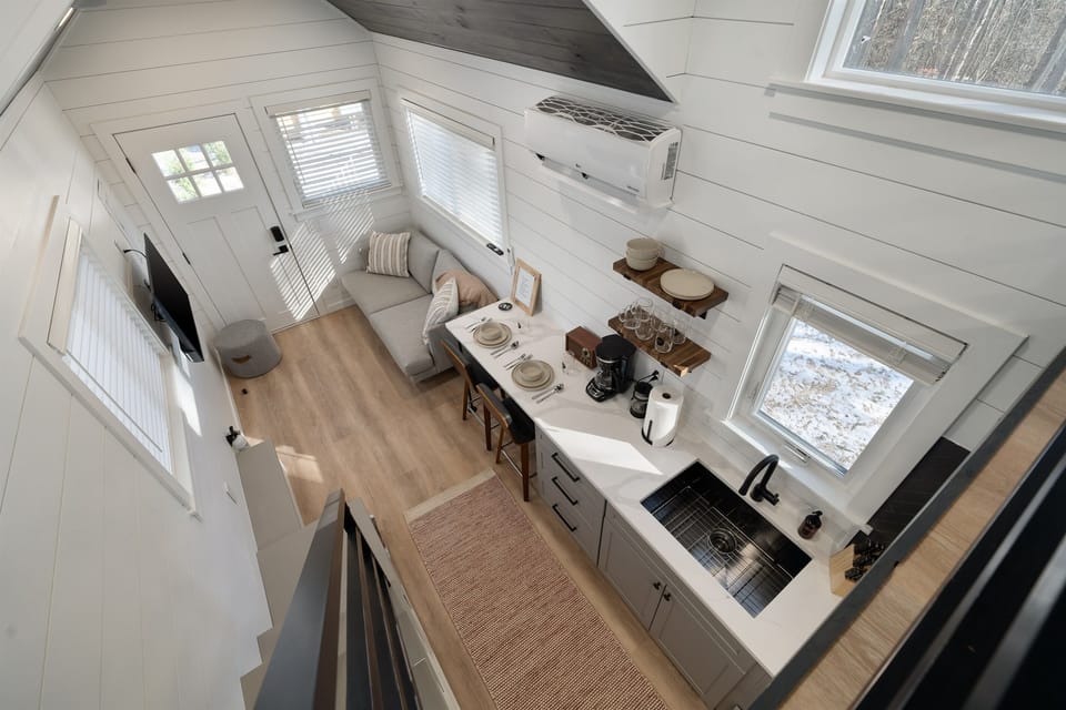 Main floor overview from above at Yeats — open layout, kitchenette, living area, and lofted bed all visible