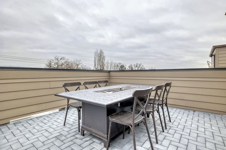 Rooftop patio w/table and chairs and built in gas fireplace