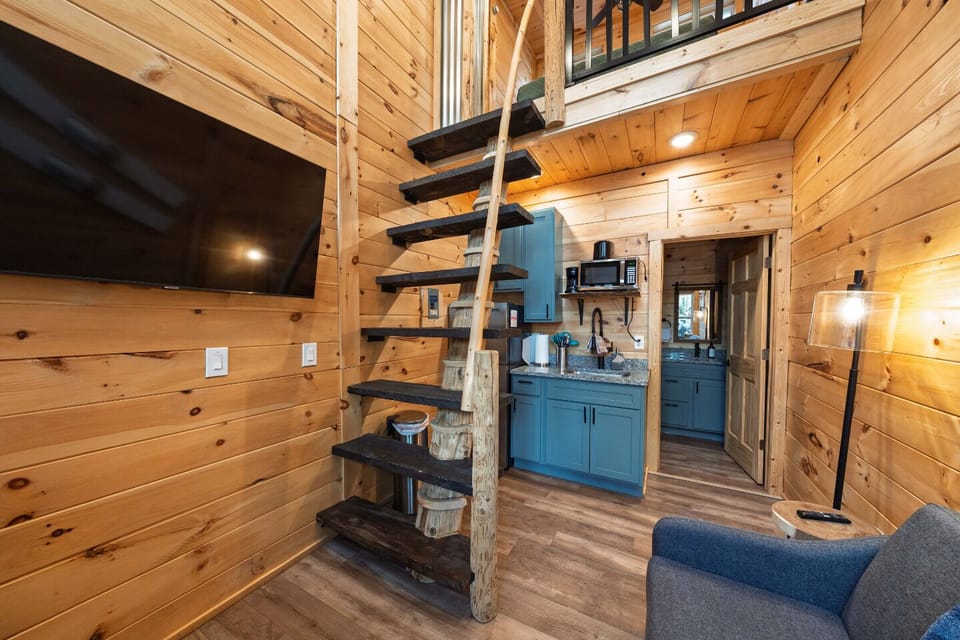 Stylish interior with warm wood tones and a charming spiral staircase to adventure!