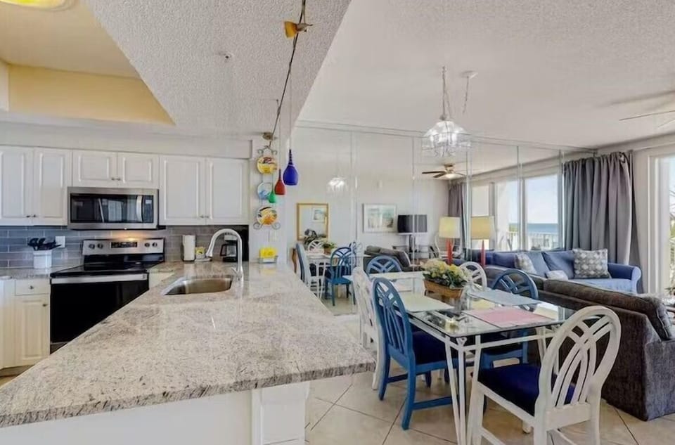Open Living Space and Gulf View Dining! This condo is updated with new flooring, furniture, and furniture + incredibly appealing, coastal decor!