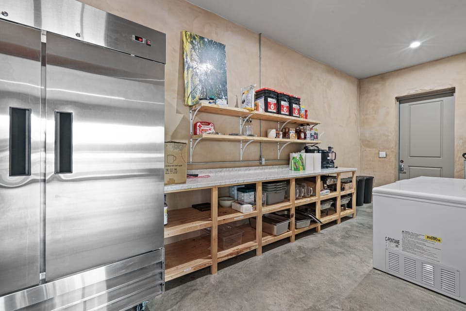 Spacious pantry with commercial cooler & chest freezer.