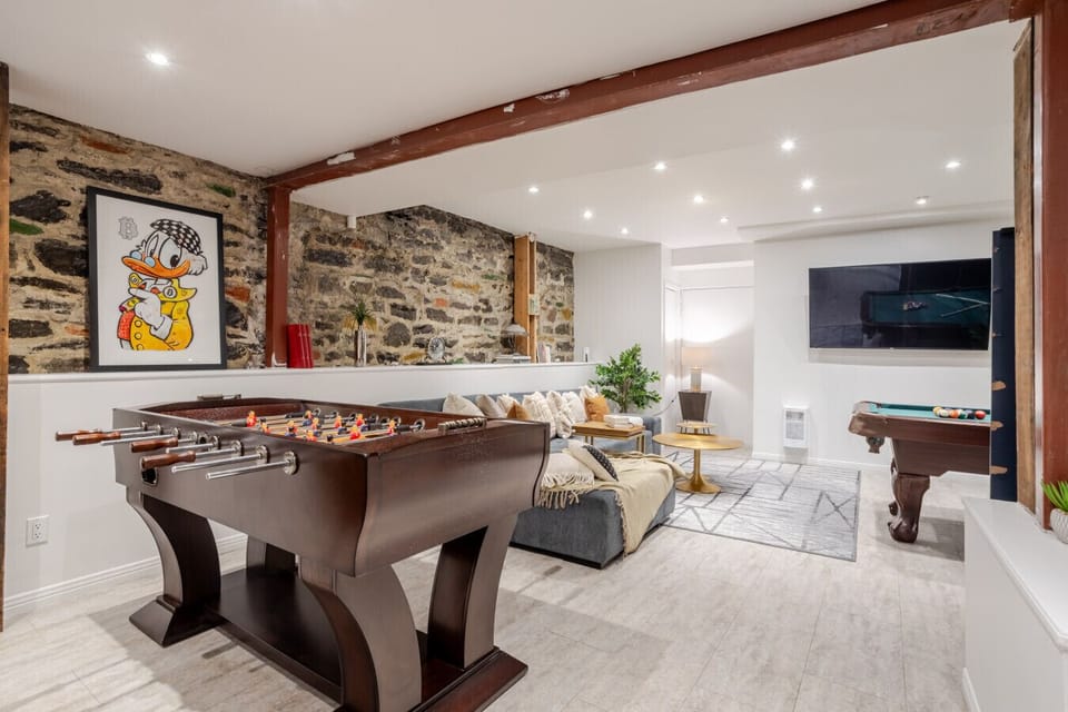 Game & Lounge View: Open space with foosball, pool, and cozy seating.