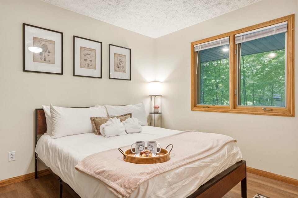 Wake up to peaceful forest views and sink into a plush king bed designed for pure relaxation. Thoughtfully styled with cozy touches, soft linens, and a warm, inviting atmosphere, this bedroom is the perfect retreat after a day of adventure.