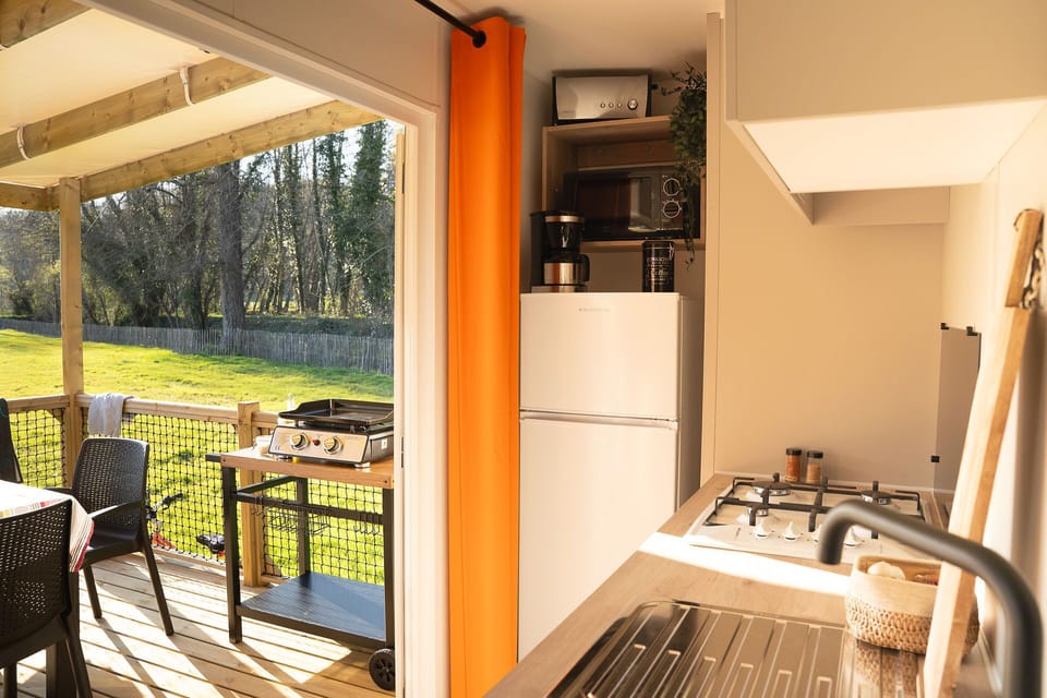 This inviting kitchen overlooks a spacious terrace, perfect for family gatherings and outdoor dining.