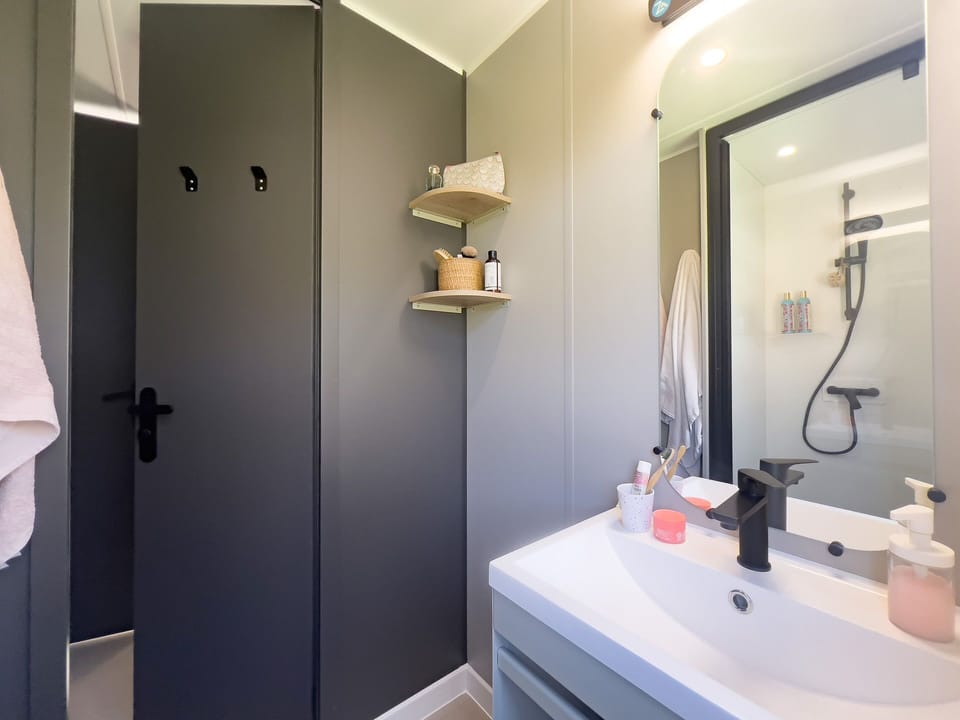 The well-appointed bathroom offers modern amenities, providing convenience for families enjoying their outdoor adventures.