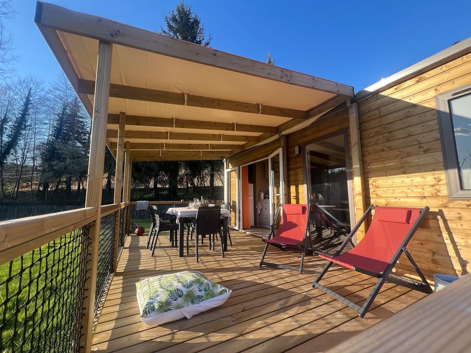 This inviting outdoor space features comfortable seating and ample dining options, making it the perfect setting for family meals and relaxation under the sun.