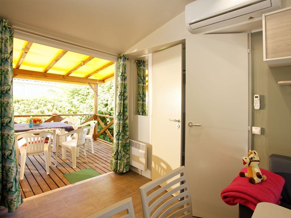 Enjoy a bright and cosy living space with air conditioning and a covered terrace for outdoor dining.