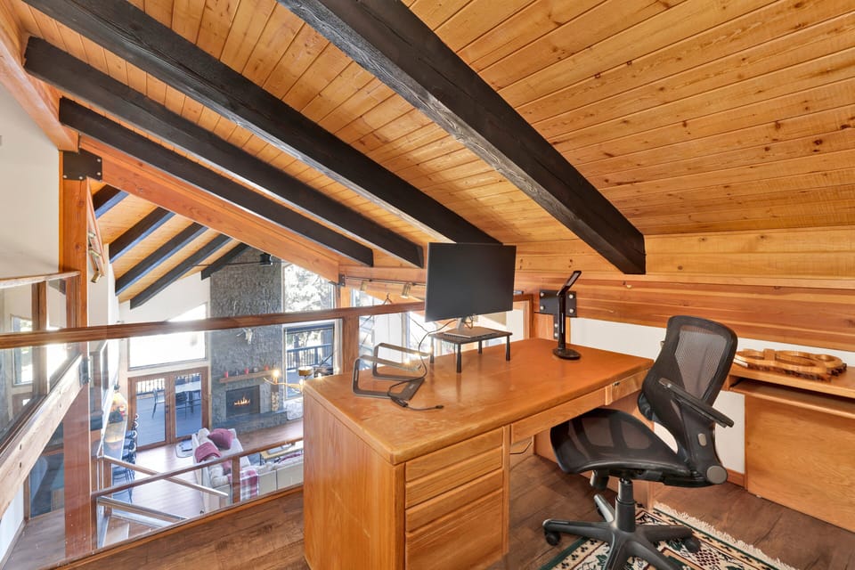 Bright office nook with desk and chair, offering guests a quiet space for work, study, or planning their adventures.
