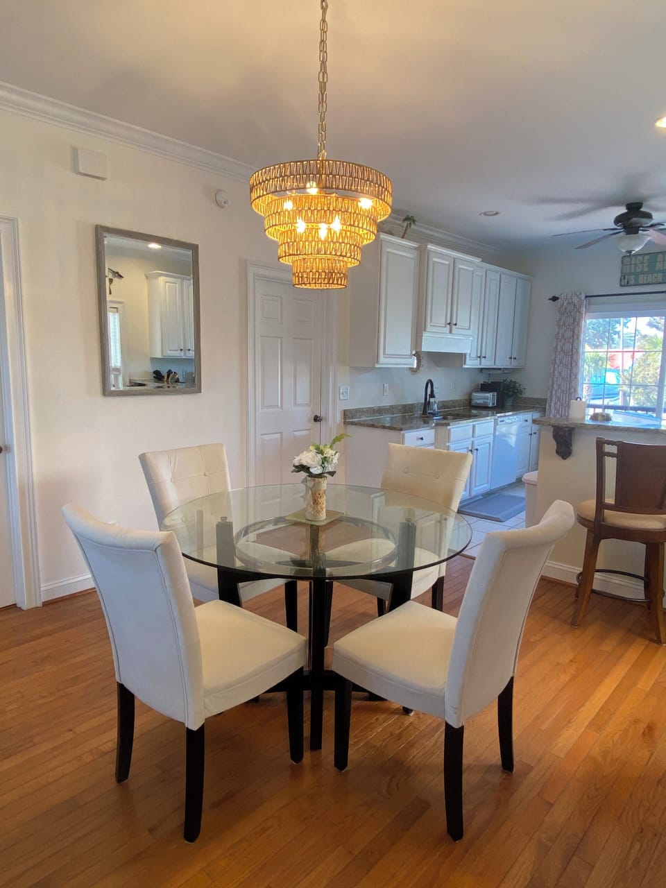Elegant dining area with chandelier and seating for four.