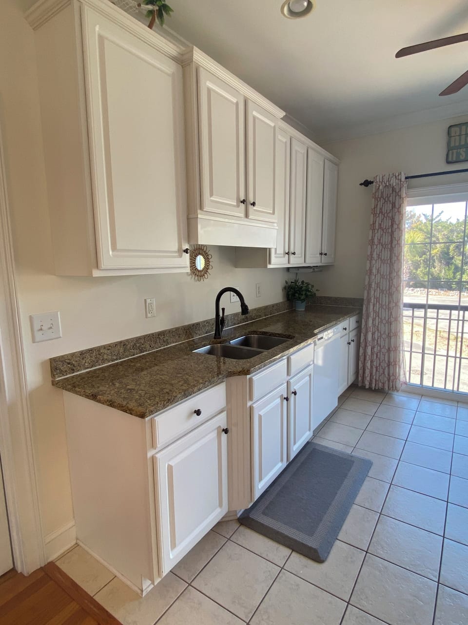 Bright kitchen nook with granite countertops and window view.