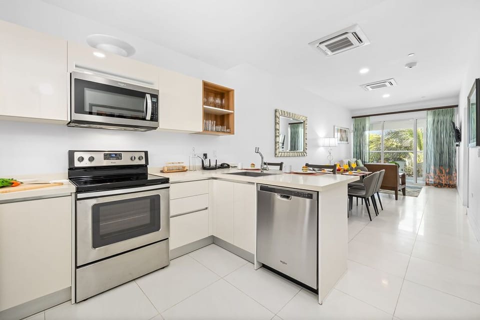 Modern kitchen featuring a dishwasher, oven, and microwave.