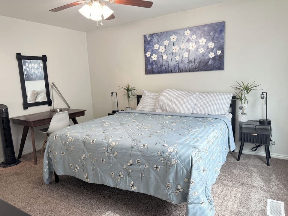 Master bedroom (upstairs) w/ king size bed, smart TV, working desk & fan