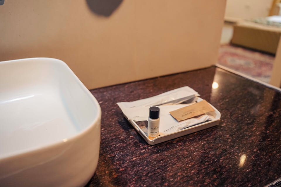 King Room | Bathroom | Designer toiletries, slippers, towels, soap