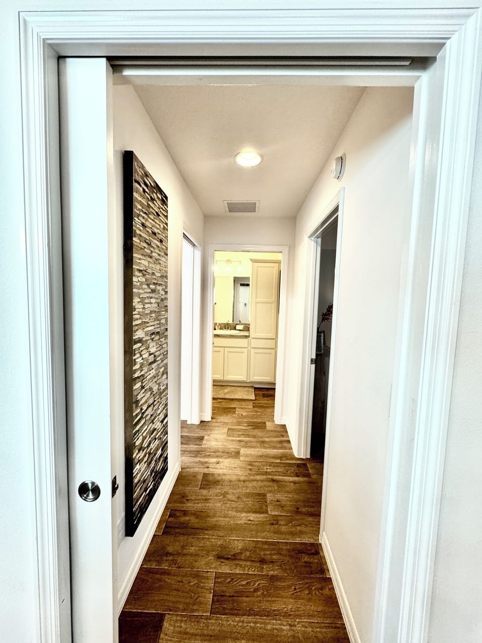 Guest Wing with Pocket Door: Laundry(left), Guest Bathroom (straight ahead)  and Guest Bedroom #2 (Right)