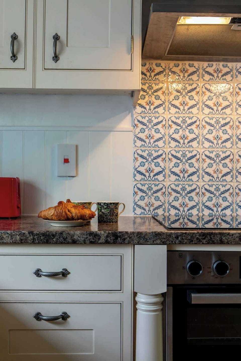 Kitchen detail - induction hob and electric oven.