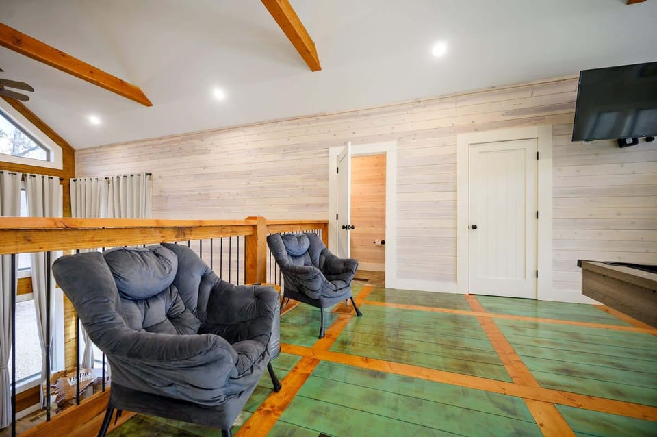 Loft with 2 queen murphy beds, pool table, half bathroom, and access to a spacious deck 