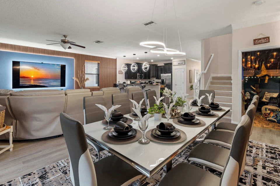Beautiful open floorplan connects the dining room, living room and kitchen. 10 top table, barstools at the counter and outdoor dining table offer plenty of room for large groups to dine together!