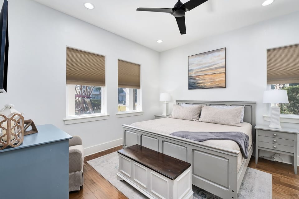 1st floor coastal Bedroom #1 with a king bed has a flat-screen TV.