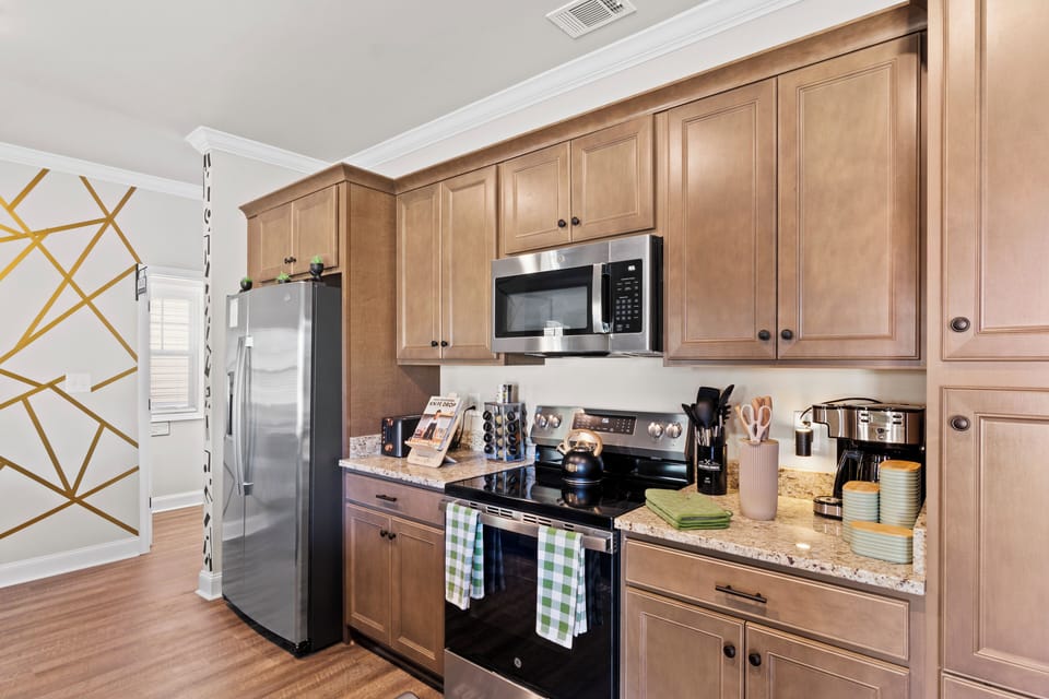 Fully-stocked kitchen complete with modern appliances, and cookware. 