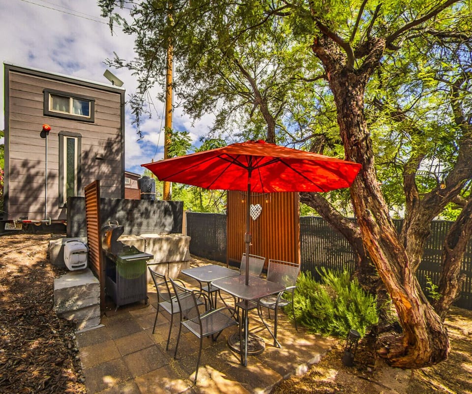 Dine outdoors on your private patio featuring a dining table, gas grill, and shaded seating, creating the perfect setting for meals surrounded by nature.